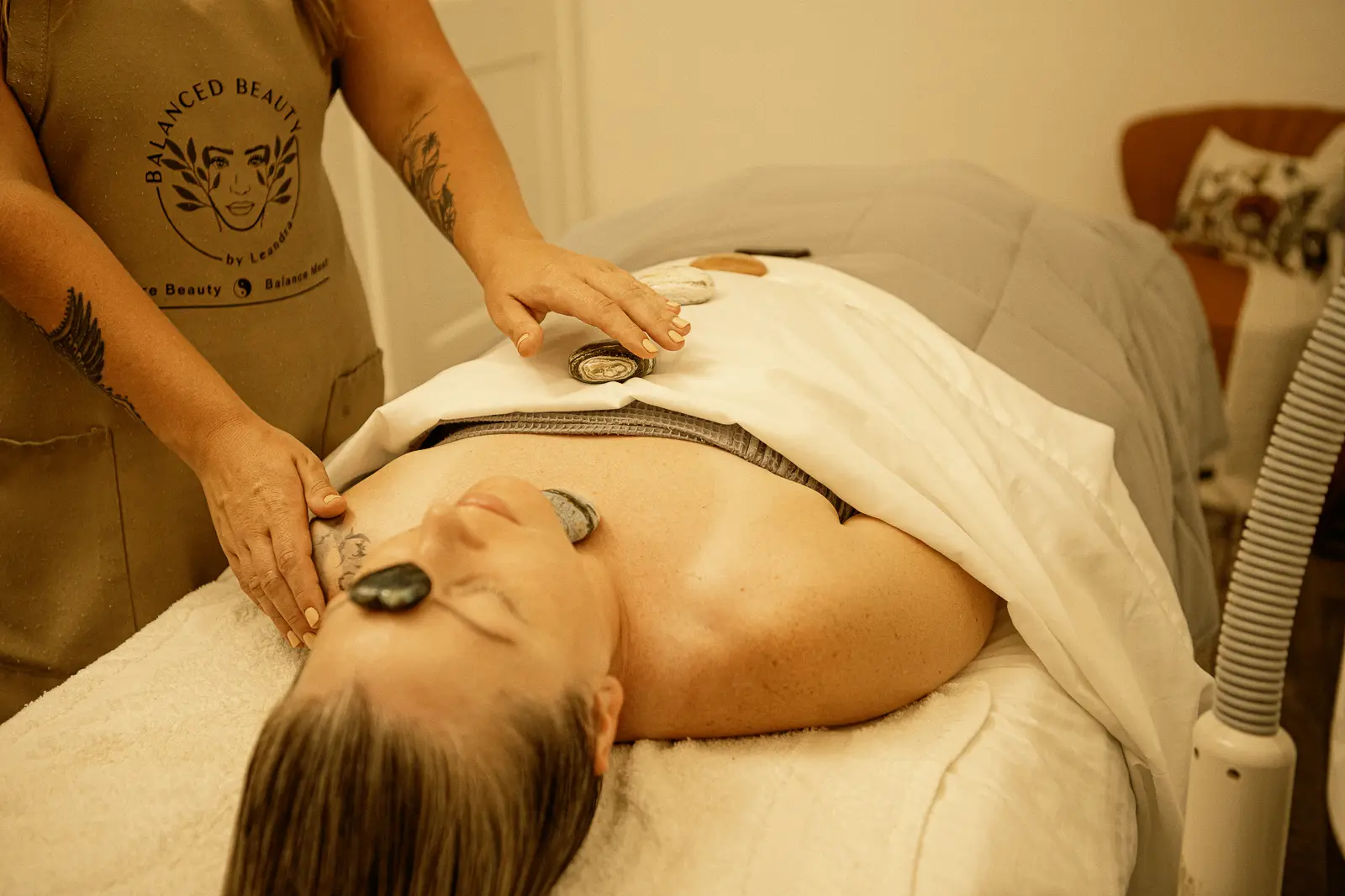 Leandra performing a customized facial with facial stones